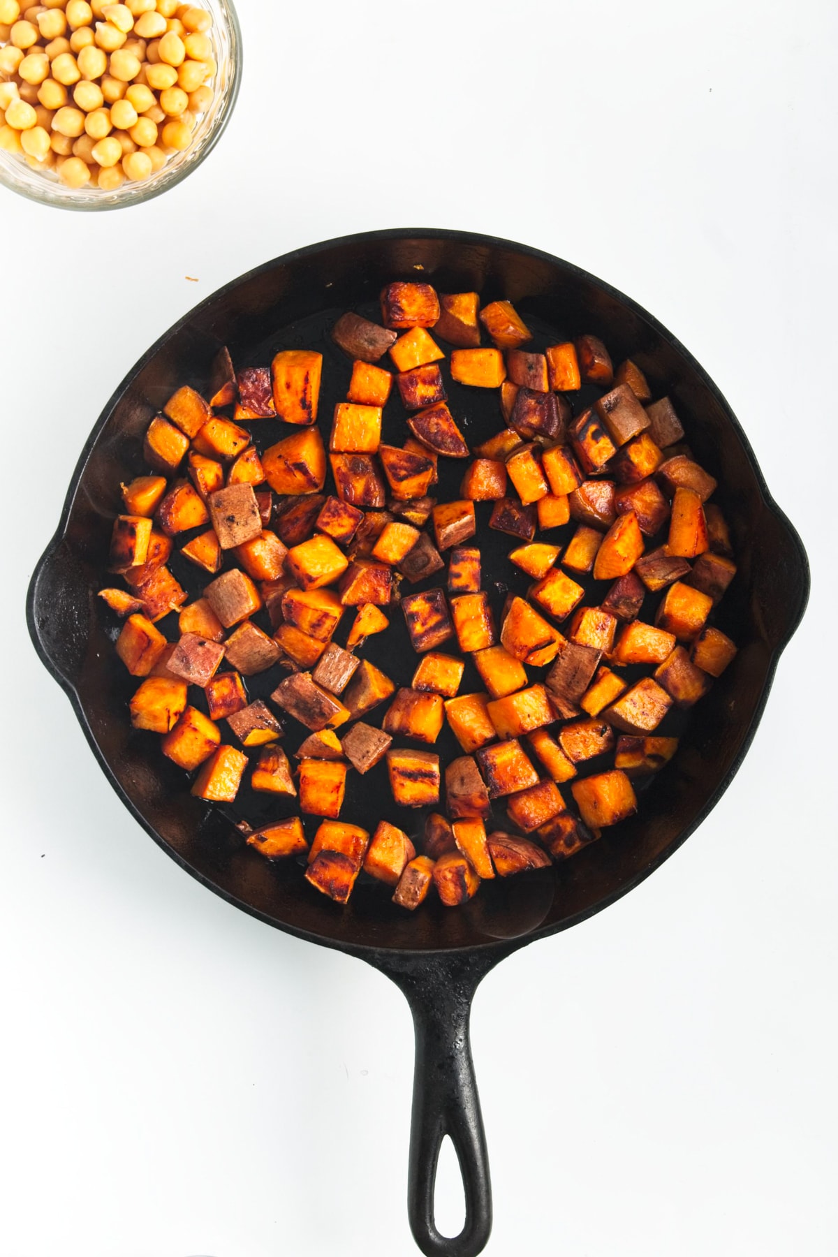 cooked sweet potatoes in a black skillet