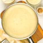 large pan of creamy white sauce on a cutting board
