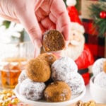 hand picking up a vegan rum ball from a stack