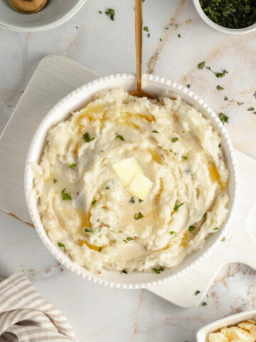 dairy-free-mashed-potatoes-with-butter on a marble table