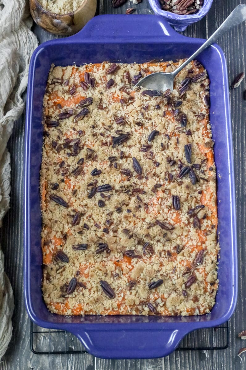 overhead closeup view of sweet potato casserole in a blue dish