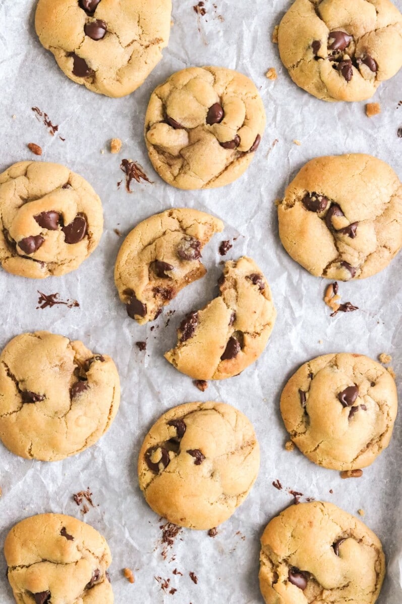 vegan chocolate chip cookies on a parchment lined cookie sheet