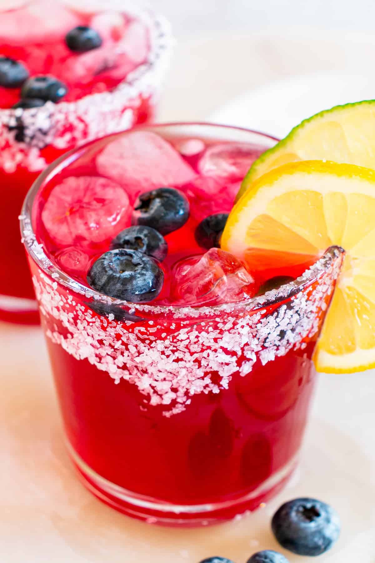 closeup of blueberry lemonade margarita with a salt rim