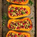 4 stuffed butternut squash on a sheet pan