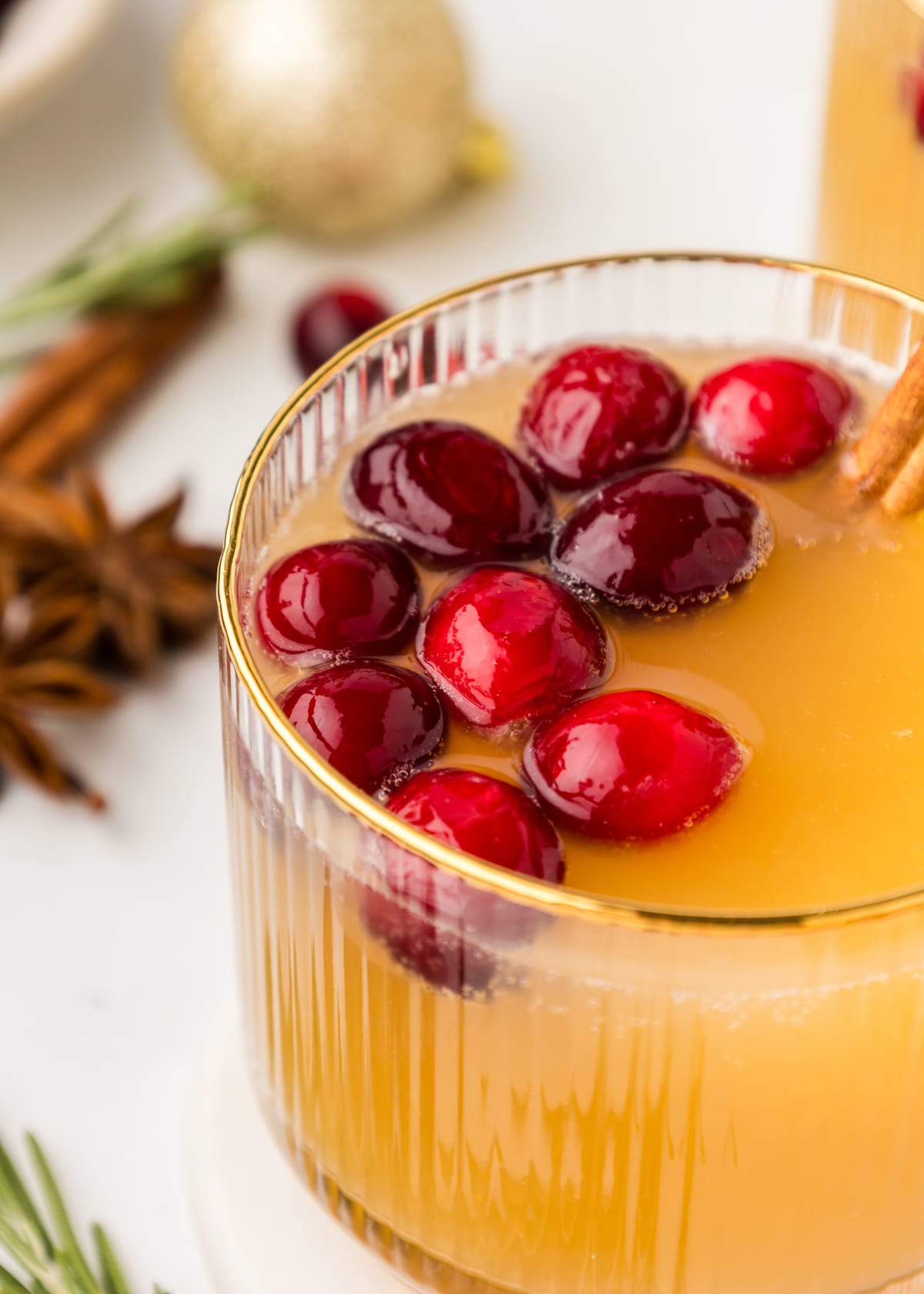 Christmas Old Fashioned Cocktail topped with fresh cranberries