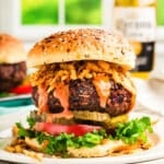 vegan black bean burger on a white plate with all the trimmings
