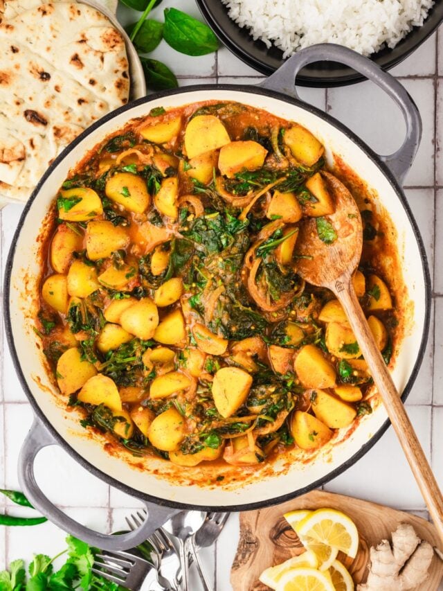 overhead view of a skillet of spinach and potato curry