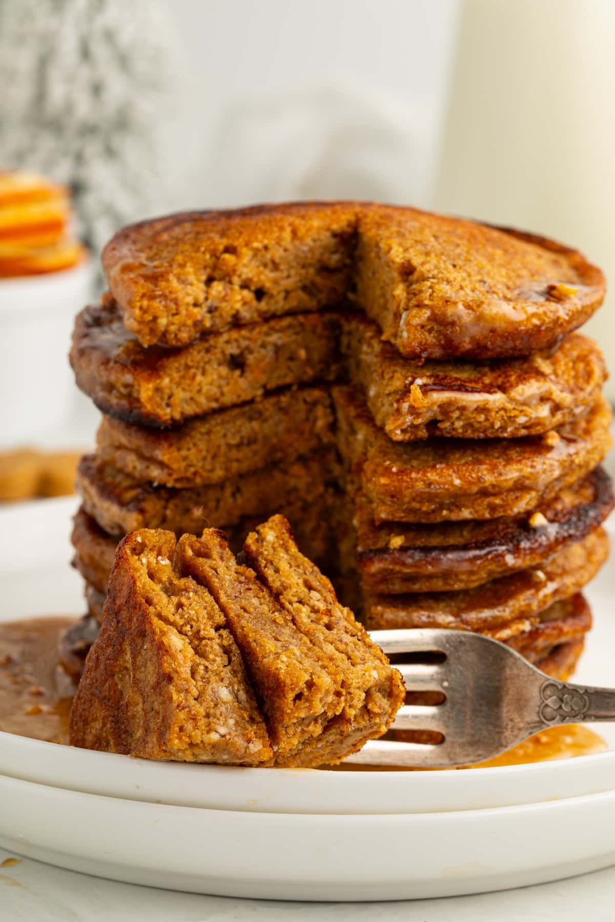 forkful of vegan gingerbread pancakes next to a stack