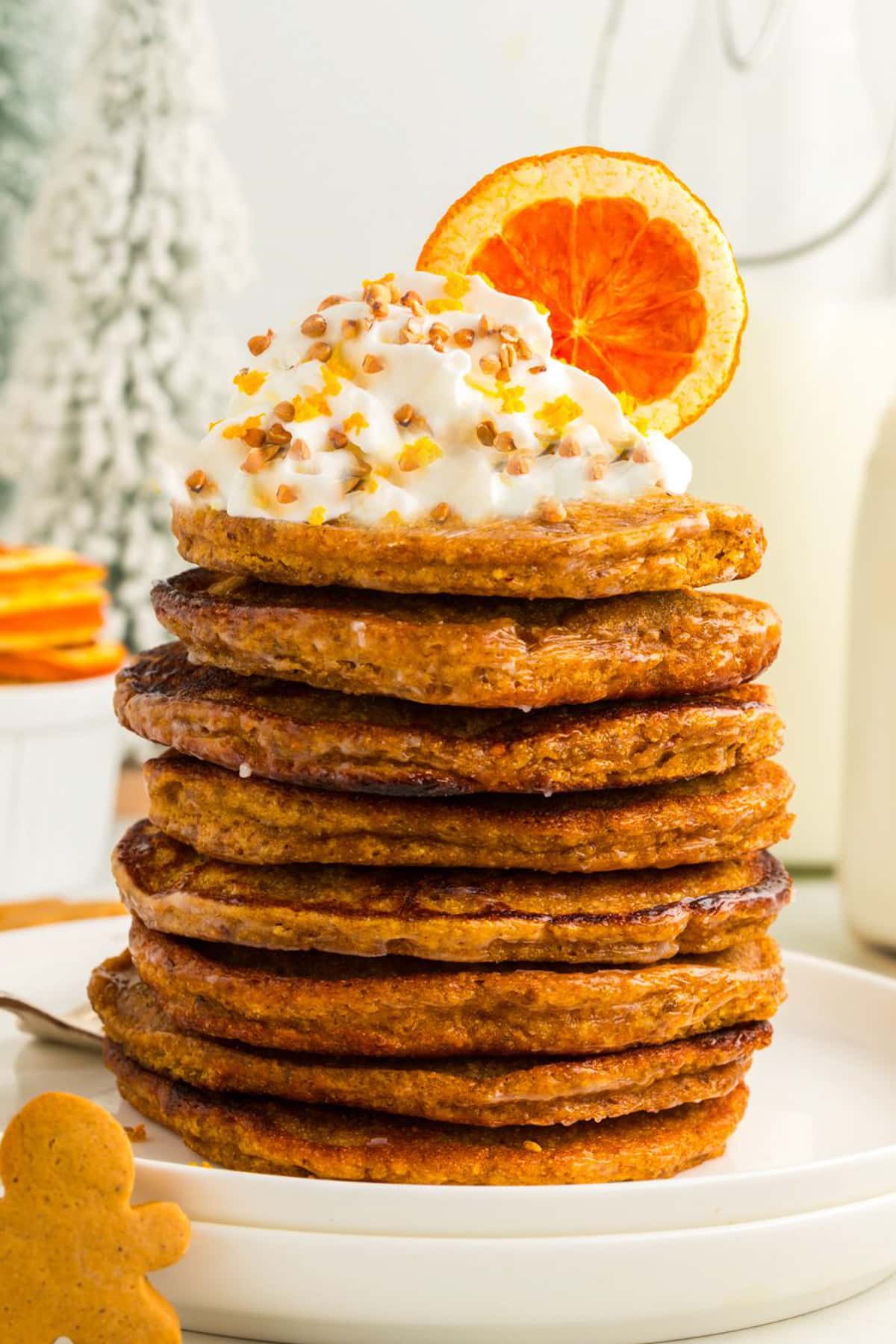 cropped gingerbread pancakes stacked on a white plate