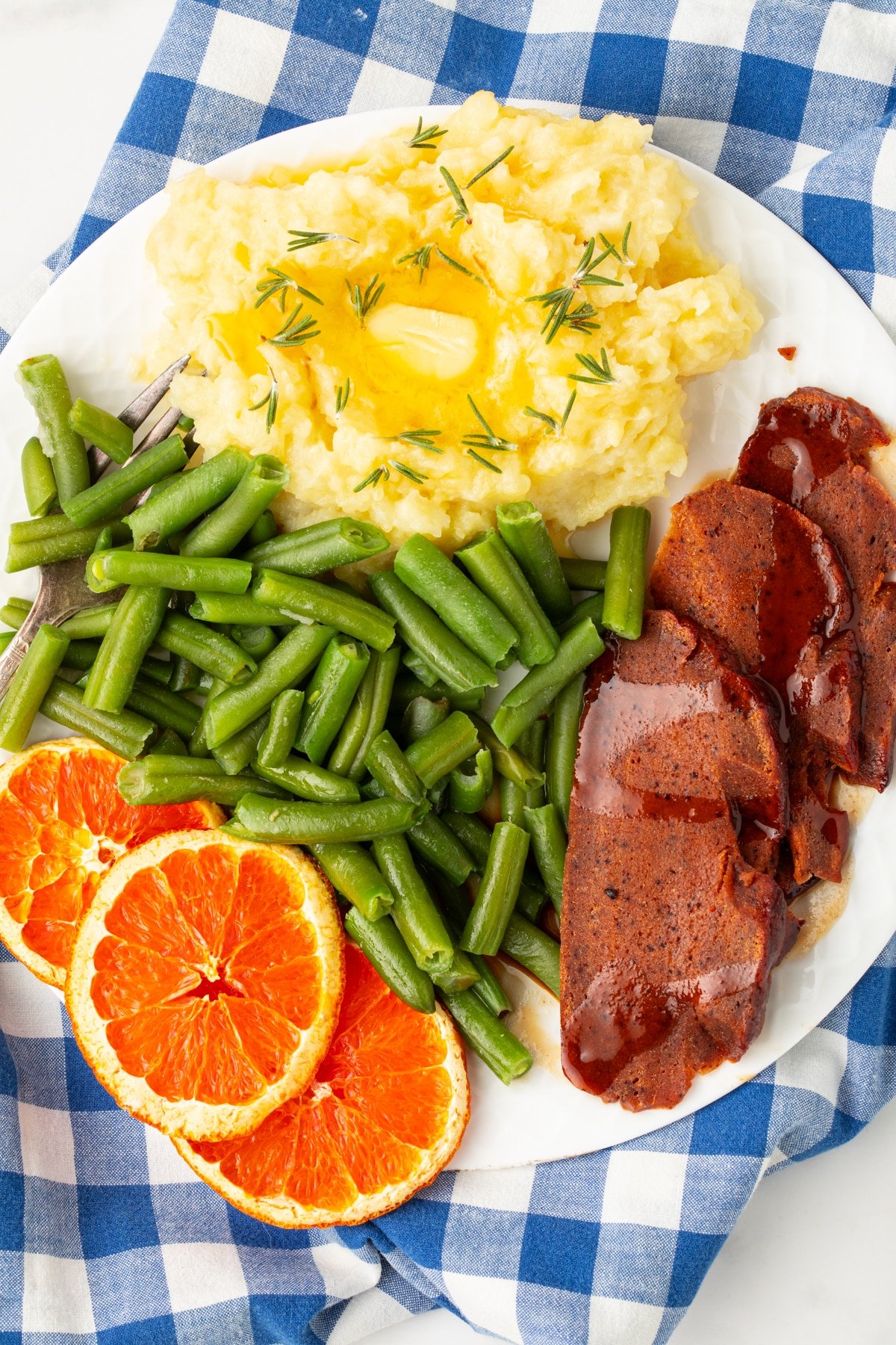 plate of vegan ham slices with trimmings