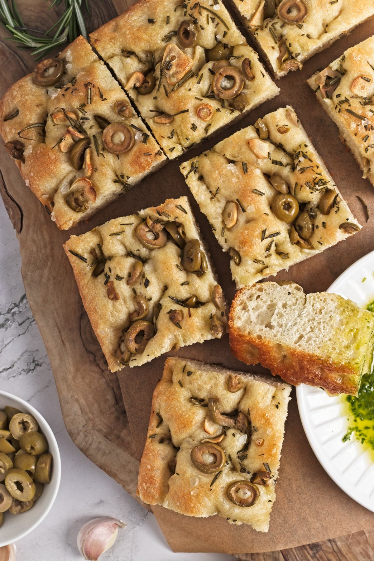 slices of garlic and rosemary focaccia on a wooden cutting board
