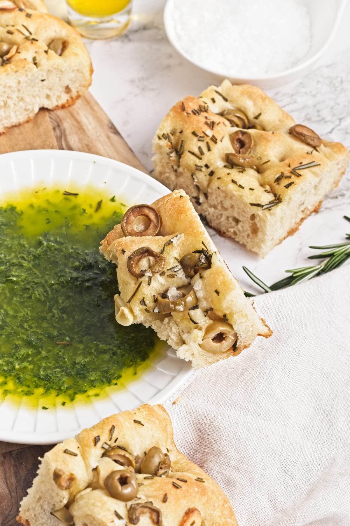 slices of garlic and rosemary focaccia ready to dip into zhoug sauce