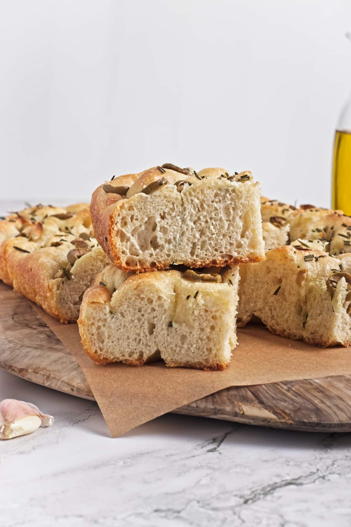 stacked slices of garlic and rosemary focaccia on a cutting board