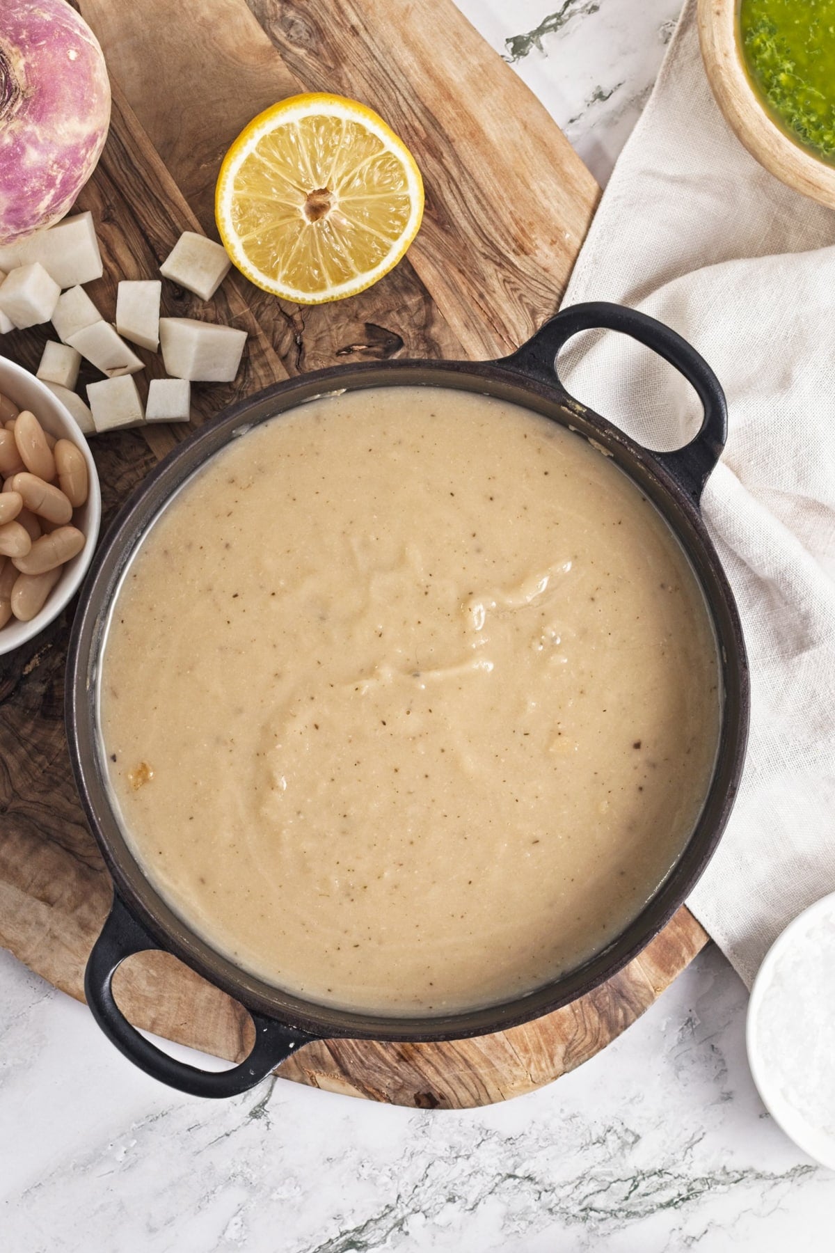 overhead view of turnip soup recipe in a black cast iron pot