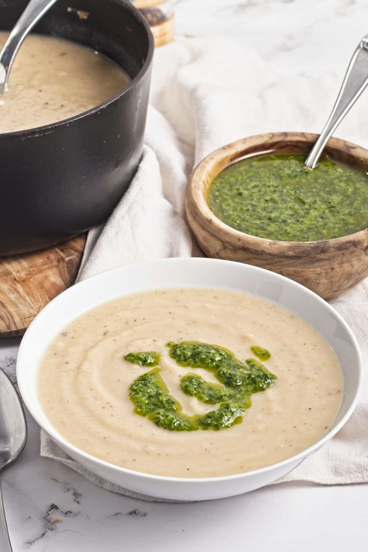side view of turnip soup in a white bowl