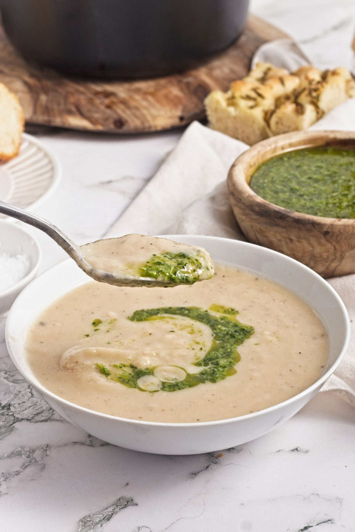 spoonful of turnip soup garnished with zhoug sauce