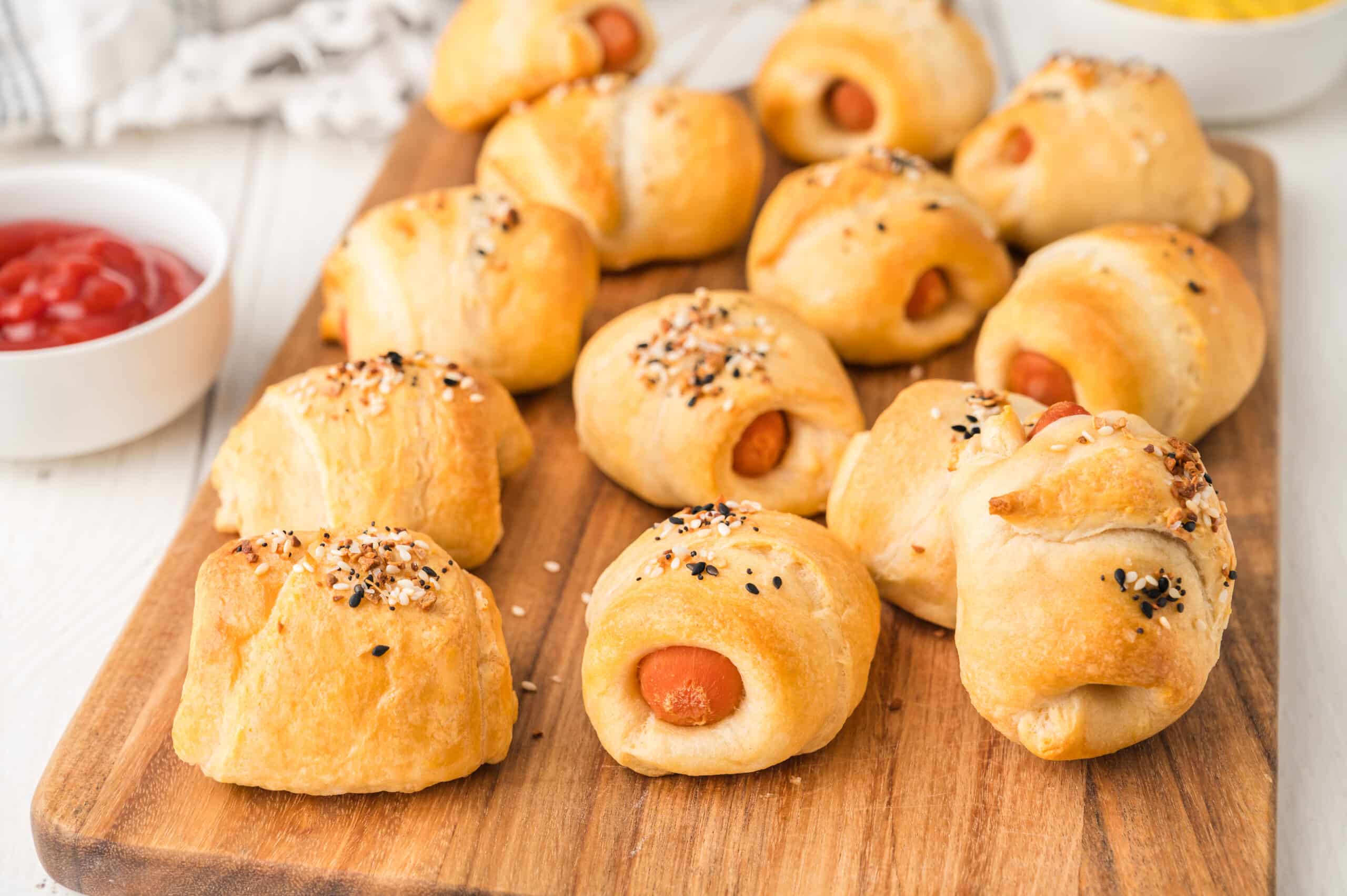 brown board full of baked vegetarian pigs in a blanket