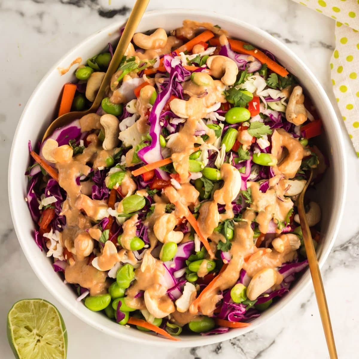 chopped thai salad in a white bowl with peanut dressing