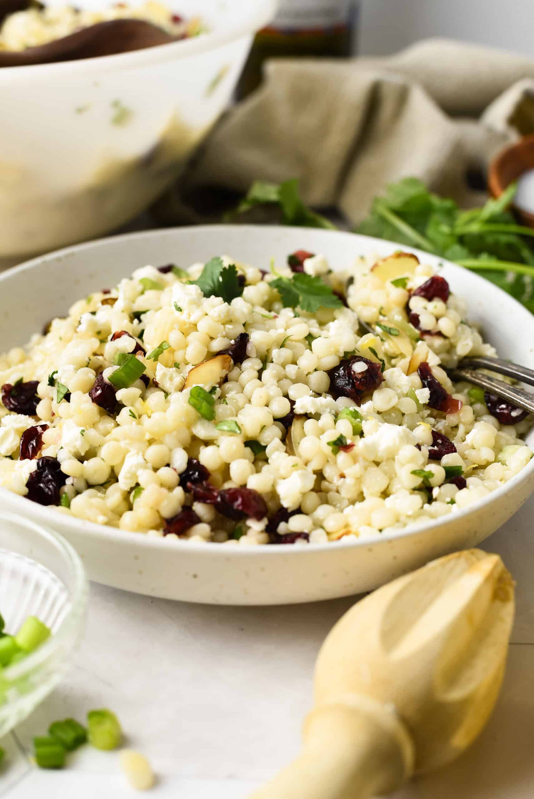 a white bowl of Pearl Couscous Salad