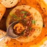 spoon scooping out the center of an onion boil