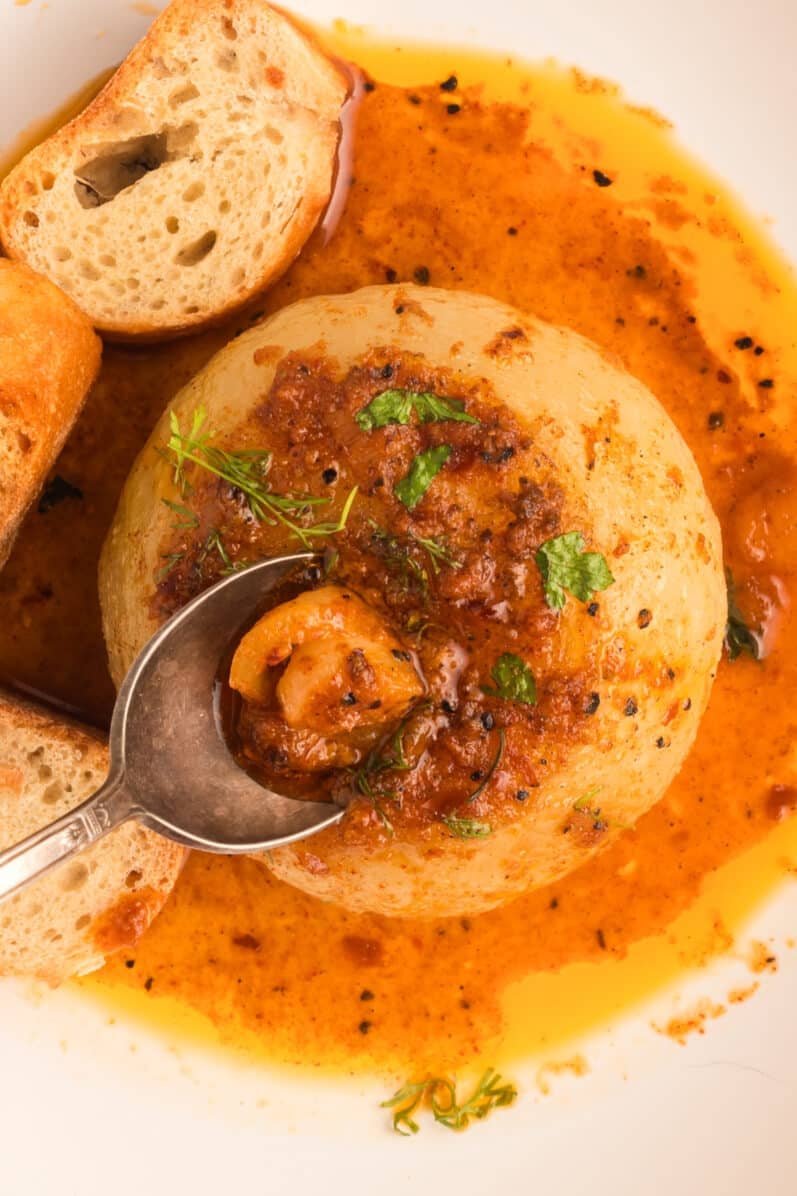 spoon scooping out the center of an onion boil