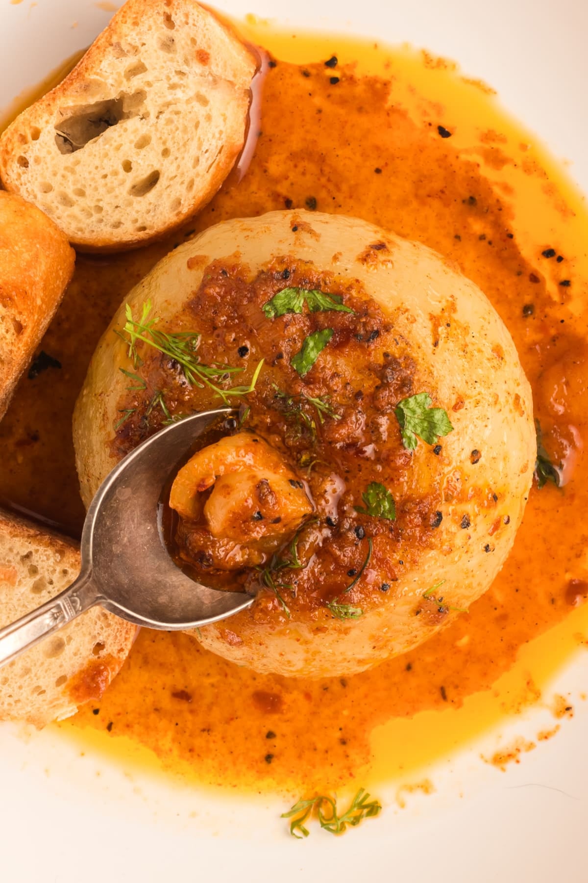 spoon scooping out the center of an onion boil