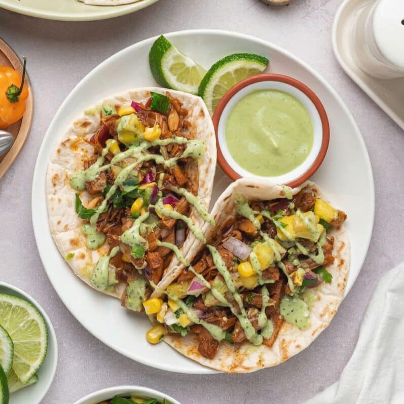 vegan jackfruit tacos on a white plate